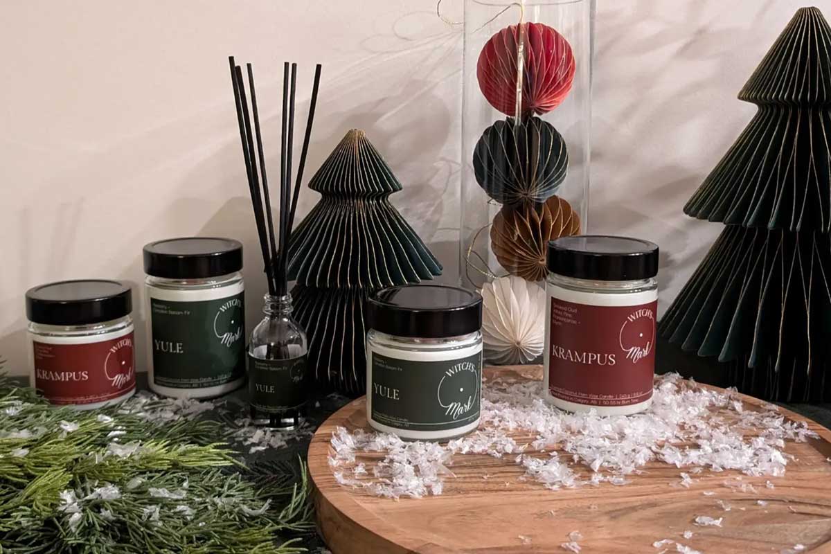 A holiday product display of Krampus and Yule candles and diffusers by Witch's Mark.